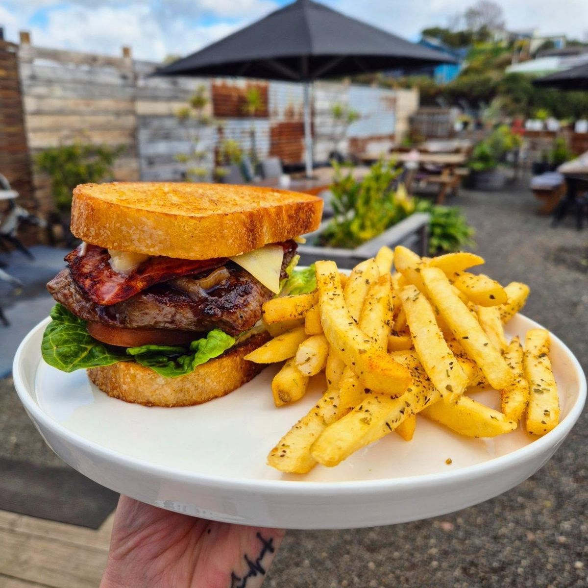 A steak sandwich with chips