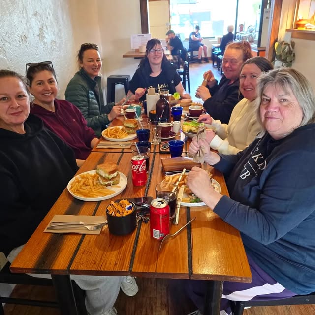 A table of locals catching up at Hey Buddy